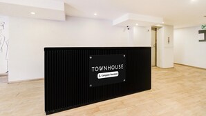 A reception area with a sign reading "TOWNHOUSE Company-Serviced." - Deluxe Super Townhouse Lakdikapul (Hyderabad)