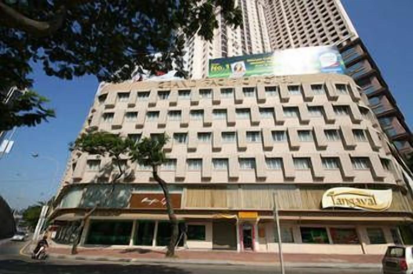 A multi-story building with commercial spaces on the ground floor, including a visible storefront with a sign.