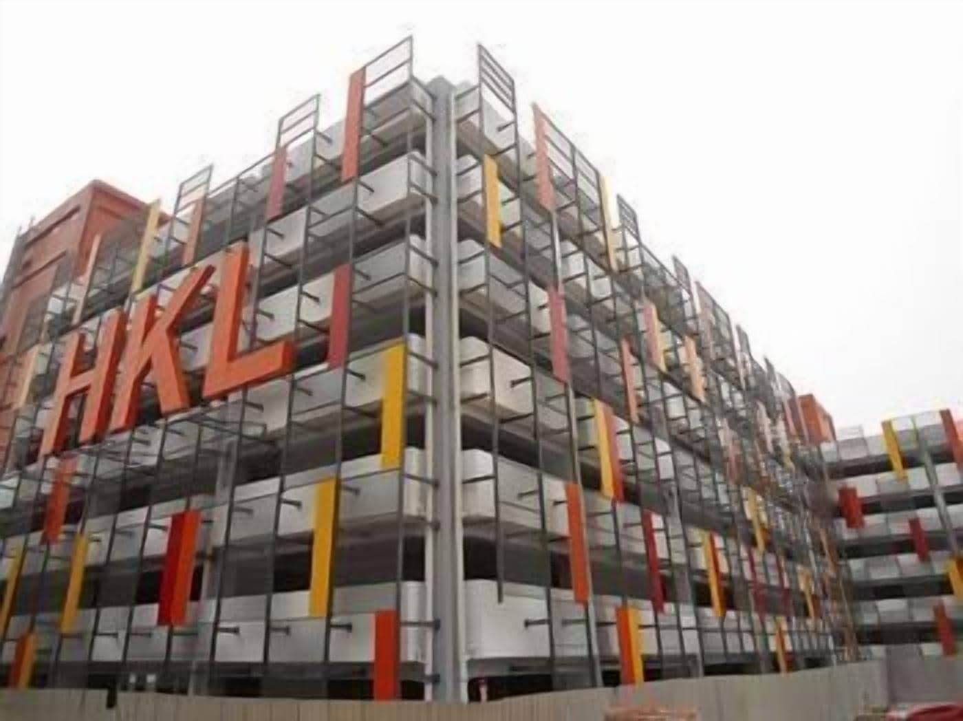 A multi-story building with a visible 'HKL' sign, indicating it is a hotel.