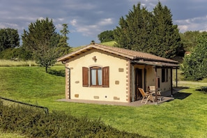 A small, single-story building with a tiled roof, a door, and a window with wooden shutters. - Nice apartment in villa with pool, WIFI, A/C, TV, patio, pets allowed and panoramic view (Perugia)