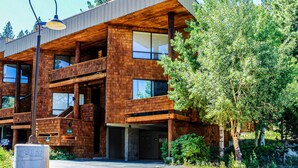 A modern building with a wooden facade, large windows, and a visible staircase. - Comfortable, chic condo with mountain views - great Olympic Valley location (Squaw Valley)