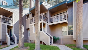 A multi-story residential building with a central staircase, balconies, and a covered outdoor area. - Lofted gem close to the lake with pool, hot tub, beach access & WiFi (South Lake Tahoe)