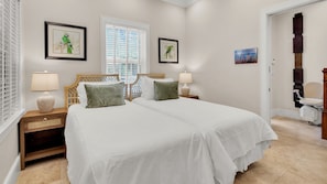A hotel room with a large bed, two bedside lamps, a wooden nightstand, and a window with blinds. - **THE ELEGANT EGRET @ OLD TOWN** Home & Pool + Last Key White Glove Service... (Key West)