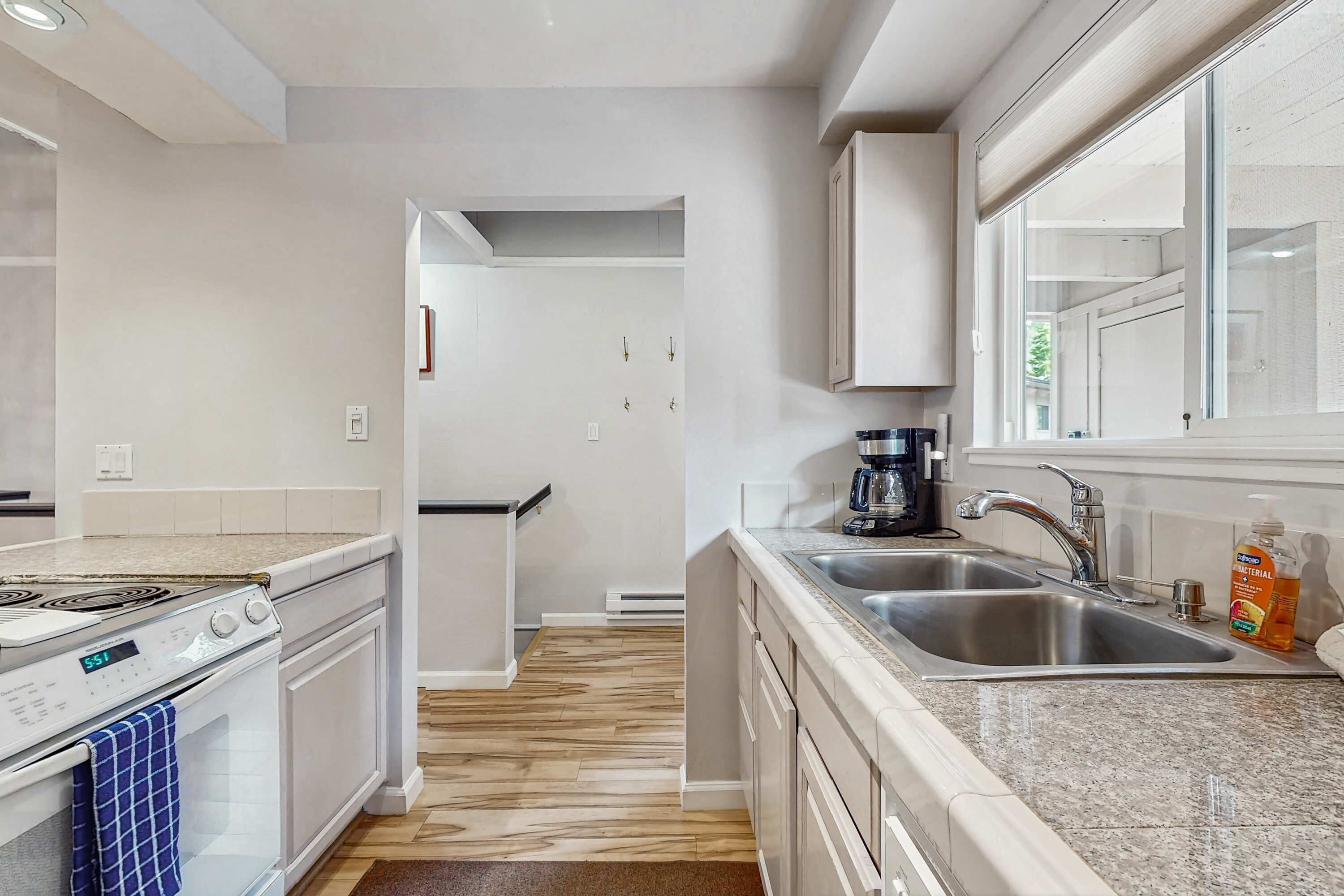 A modern kitchen with a stove, oven, and sink.