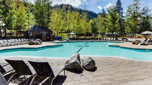 A swimming pool with lounge chairs and a gazebo, surrounded by trees and a mountain backdrop. - Ski getaway with amazing mountain views, fireplace, pool, & river path access (Olympic Valley)