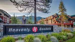 A sign for 'Heavenly Gondola' with a stone wall and landscaped garden. - Family Home with Fast WiFi, Wood Stove, Firepit, & Enclosed Yard - Dogs OK (South Lake Tahoe)
