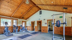 A gym with exercise equipment, wooden walls, and a high ceiling. - Centrally-Located Condo near Ski Resorts with Gas Fireplace (Truckee)
