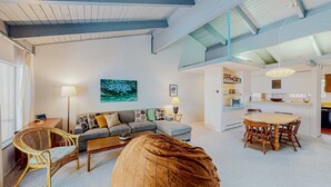 A modern living room with a sofa, a dining table, and a bean bag. - Dog-friendly condo with pool access, fireplace, private washer&dryer, & wet bar (Incline Village)