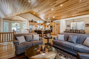 A spacious living room with two sofas, a coffee table, and a wooden ceiling. - Inviting spacious home with fireplace, deck, hot tub, full kitchen, & W&D (South Lake Tahoe)