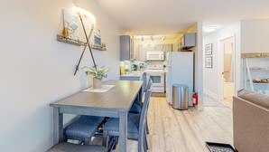 A modern kitchen with white cabinets, a microwave, and a stainless steel refrigerator. - Tranquil condo in Stateline, sleeps 4 (Stateline)