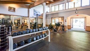 A gym with weightlifting equipment, mirrors, and a large window. - Sophisticated Gold Bend Getaway | Fireplace | Free Ski Shuttle, Pool, Hot Tub (Northstar - Truckee)