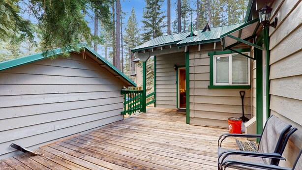 A wooden deck with a bench, a small porch, and a shed with a window. - Tahoe Getaway: Spacious Deck, Fireplace & Family-Friendly (South Lake Tahoe)