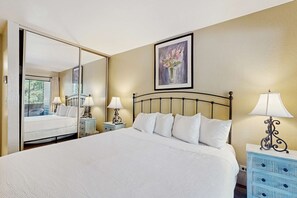 A hotel room with a large bed, two bedside tables with lamps, a mirror, and a painting on the wall. - Explore the magic of Lake Tahoe and nearby Heavenly (South Lake Tahoe)