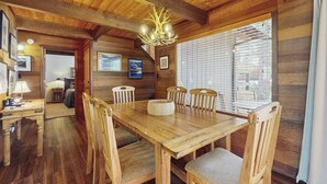 A wooden dining area with a large table, chairs, and a chandelier. - Spacious Northstar Lake Retreat – Perfect for Families & Groups ️ (Truckee)