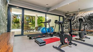 A modern gym with treadmills, ellipticals, and exercise balls. - Stay With Pool in Promajna (Baska Voda)