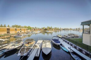 A marina with boats docked, a building with a balcony, and a clear sky. - Tahoe Keys Waterfront Escape (South Lake Tahoe)