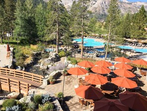 A resort with a pool, outdoor seating, and a wooden bridge. - Ski-in-ski-out Everline Resort & Spa - two adjacent units (Olympic Valley)