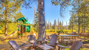 A park with Adirondack chairs, picnic tables, and a playground. - Dog-friendly snowbird escape with pool, hot tub & sauna access, & woodstove (Truckee)