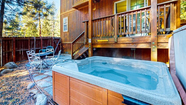 A wooden cabin with a hot tub, outdoor seating, and a deck. - Cozy, enchanting retreat with hot tub, stunning deck, & balcony - close to beach (Kings Beach)