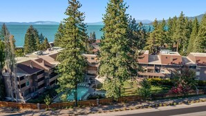 A residential area with a swimming pool, multiple buildings, and a clear view of the ocean. - Lakefront retreat with shared pool, hot tub, & sauna - near shopping & skiing (South Lake Tahoe)