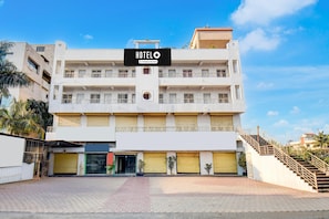 A multi-story hotel with a prominent sign, balconies, and a staircase. - Classic With Balcony Hotel Galaxy Inn (Junnar)