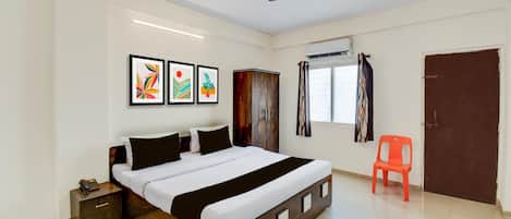 A bedroom with a bed, bedside tables, a wardrobe, a ceiling fan, and a window with curtains.