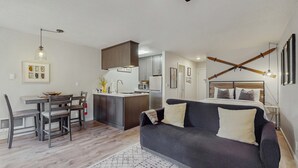 A compact living space with a kitchenette, a dining area, a sofa, and a bed. - Cozy Studio with Full Kitchen, Grill, Fireplace w/Access to Pool, Spa, Game Room (Tahoe Vista)