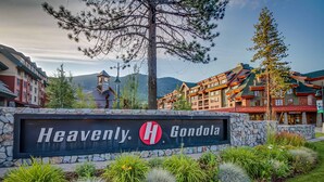 A sign for 'Heavenly Gondola' with a stone wall and landscaped garden. - Condo near Lake Tahoe with pool, hot tub, grill, & wood fireplace - sleeps 6 (Stateline)