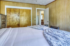 A bedroom with a bed, a dresser, and a mirror. - Complimentary paddle boards and a relaxing sauna just steps from Lake Tahoe. (Carnelian Bay)