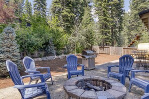An outdoor seating area with Adirondack chairs, a fire pit, and a grill. - Complimentary paddle boards and a relaxing sauna just steps from Lake Tahoe. (Carnelian Bay)