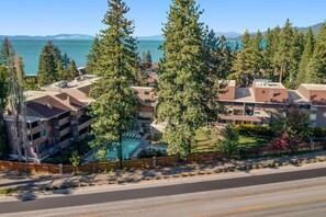 A residential area with a swimming pool, multiple-story buildings, and a clear view of the ocean. - Inviting condo near skiing with lake & beach access, pools, & hot tubs (South Lake Tahoe)