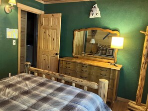 A room with a bed, wooden dresser, and a mirror. - Inviting home with pool table - near Heavenly & beaches (South Lake Tahoe)