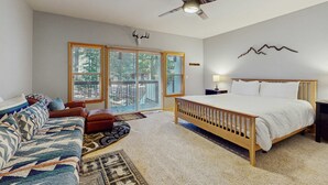A bedroom with a bed, a sofa, a ceiling fan, and a window with blinds. - Updated condo near ski resort with heated pool, hot tub, fireplace, balcony, W&D (Olympic Valley)