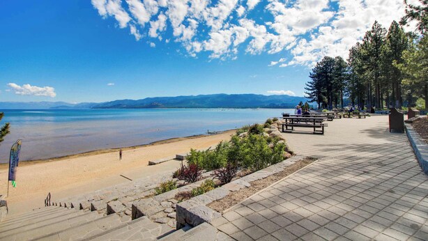 A beachside walkway with benches, a clear sky, and a calm sea. - Grand lodge in the woods near golf, hiking & skiing with multiple fireplaces (South Lake Tahoe)