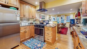 A kitchen with wooden cabinets, a stainless steel refrigerator, an oven, and a stove. - Relaxing Dog-friendly home with gas grill & private fenced yard - close to marina (South Lake Tahoe)