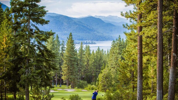 A golf course with a clear view of a lake and mountains in the background. - Cozy and Convenient Condo with Fireplace, Deck, W&D, Close to Town, Lake, Trails (Tahoe City)