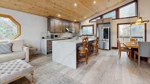 A spacious kitchen with wooden ceiling, large windows, and a central island. - Pristine Family and Dog Friendly Mountain Home with Deck, BBQ, W&D (Truckee)