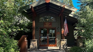 A wooden building with a sign reading 'Welcome n.p.o.a. recreation center' and an American flag. - Cozy townhouse with pool access, board games, and fireplace - near skiing (Northstar - Truckee)