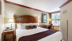 A hotel room with a large bed, two bedside tables, a desk, a chair, a window, and a mirror. - Everline Resort & Spa Ski-in-ski-out condo, pools, tennis, ice rink, & gym (Olympic Valley)