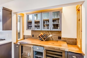 A kitchen with a wooden countertop, built-in cabinets, and a wine rack. - Golf-course home with great view, 2 fireplaces, deck & walkable location (Incline Village)