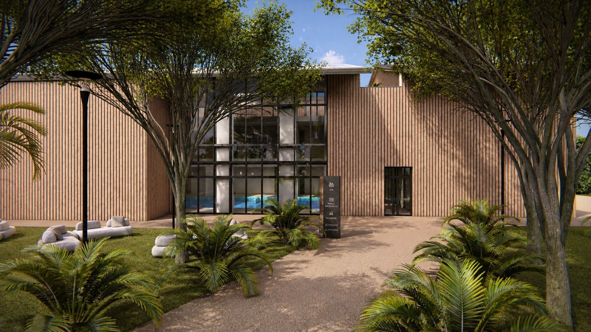 A modern building with a reception desk, a swimming pool, and a well-maintained garden with palm trees and seating areas.