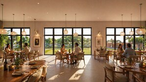 A spacious dining area with large windows, wooden tables, and hanging pendant lights. - Delta Open Air Resort (Porto Garibaldi)