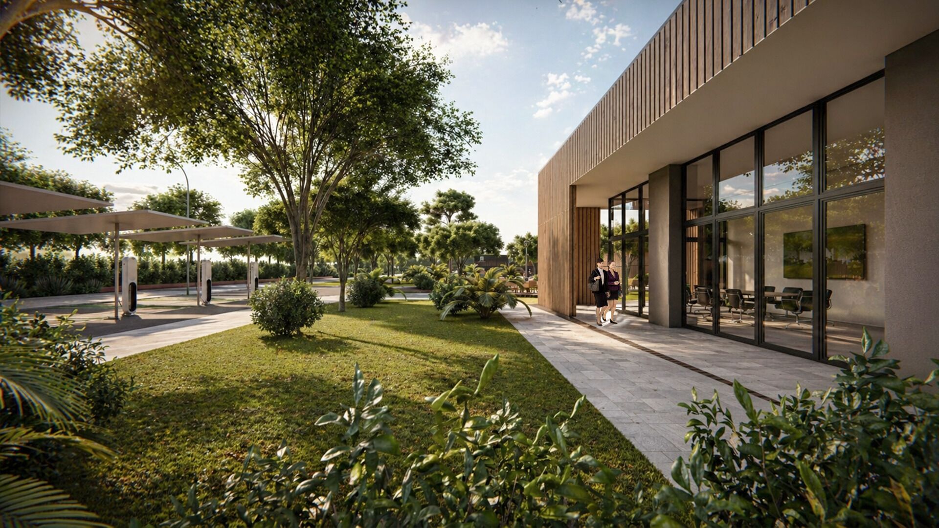 Un edificio moderno con amplios ventanales, un área de estar al aire libre techada y vegetación cuidada.