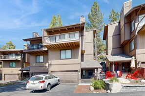 A multi-story residential building with a garage, outdoor seating area, and a car parked in front. - Kingsbury Grade home with fireplace & easy access to beaches & skiing, sleeps 6 (Stateline)