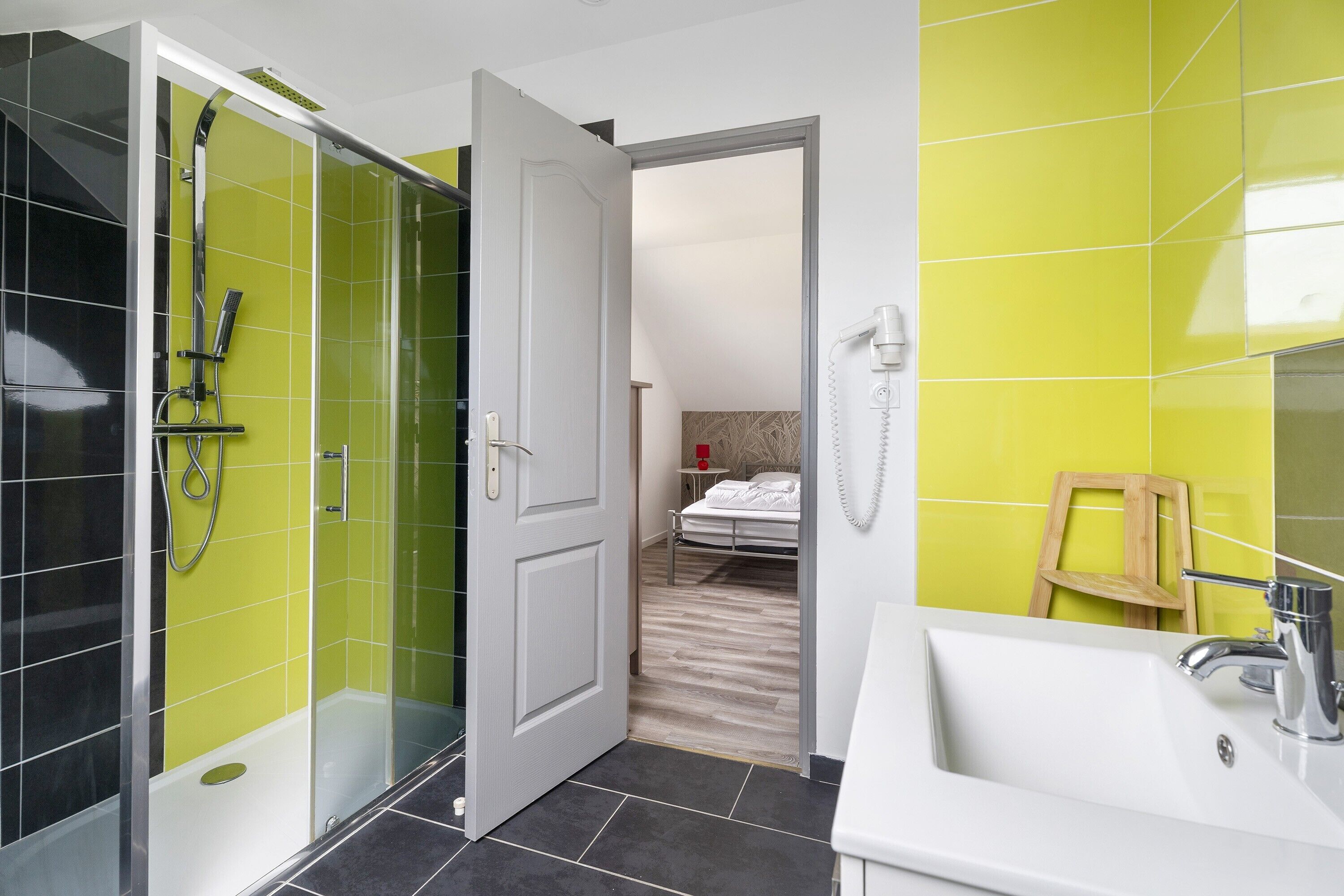 A bathroom with a shower, a sink, and a toilet.