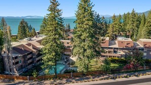 A residential area with a swimming pool, multiple buildings, and a road in the foreground. - Charming townhome with airy living space, amazing amenities, & near the beach (South Lake Tahoe)