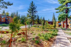 A residential area with a paved walkway, young trees, and a mix of modern and traditional architecture. - near Kings Beach & Northstar Village with balcony (Northstar - Truckee)