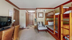A room with a television, wooden furniture, a bunk bed, and a framed picture on the wall. - Everline Resort & Spa - ski-in&ski-out studio, pools, ice rink, gym, & tennis (Olympic Valley)