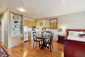 A compact living space with a dining area, kitchenette, and a bed. - First-Floor Studio w Free WiFi, Shared Heated Pool, Seasonal Pool, Private Beach (South Lake Tahoe)