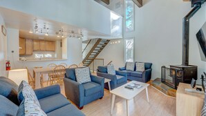A spacious living area with a staircase, a fireplace, and a dining area. - Charming Condo with Shared Hot Tub, Pool, Resort Amenities - Close to Ski & Beach (Carnelian Bay)